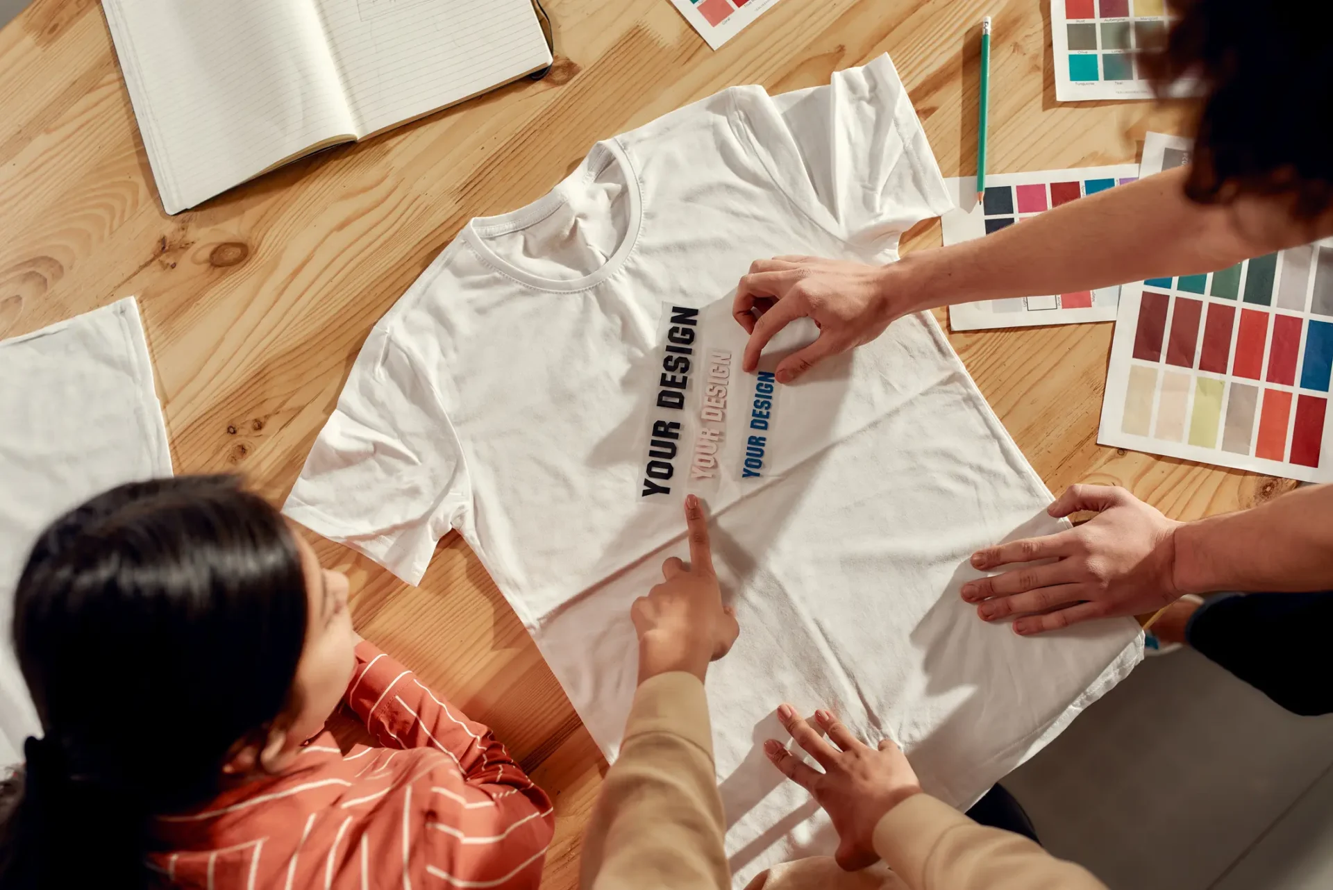 People designing a custom white T-shirt.